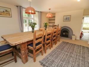 a dining room with a table and chairs and a fireplace at 9 Copes Gardens in Truro