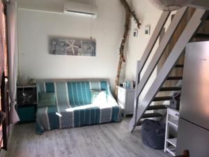 a bedroom with a bed next to a staircase at Port leucate T2 bis wifi les Sables 3 in Port Leucate