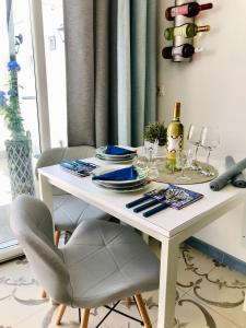 a white table with plates and wine glasses on it at B&B Le Statuine in Barletta