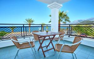 a table and chairs on a balcony with a view at Maistrali Sea View Apartments in Stalida