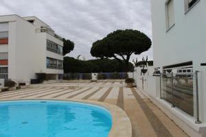 a swimming pool in the courtyard of a building at APPT T2 - BEN - La Grande Motte in La Grande-Motte