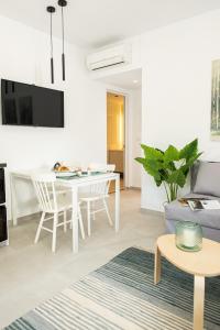 a living room with a table and a couch at Cozy Corner Luxury Apartments in Chania Town