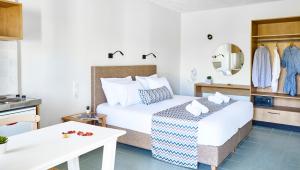 a hotel room with a bed and a table at Maistrali Sea View Apartments in Stalida