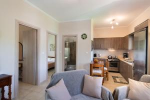 a living room with a couch and a kitchen at Villa Nektaria in Nikiana +18 photos