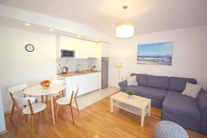 a living room with a couch and a table at Sun Apartments in Primošten