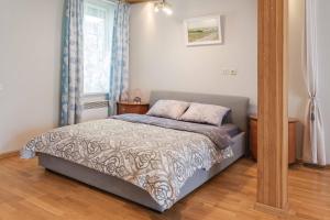 a bedroom with a bed and a window at Cozy one room apartment with yard in Juodkrantė