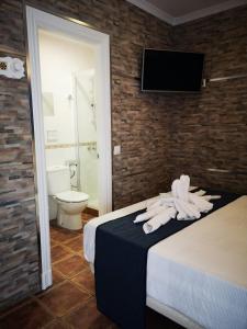 a hotel room with a bed and a toilet at Hostal Costa De La Luz in Conil de la Frontera +49 photos
