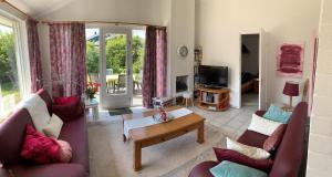 a living room with two couches and a table at Bungalow36 - Petten in Petten