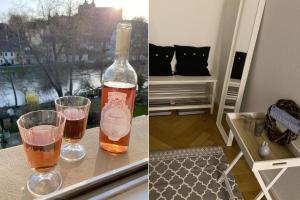 a bottle of wine and two glasses on a table at Ferienwohnung Dom- u. Regnitzblick in Bamberg +29 photos