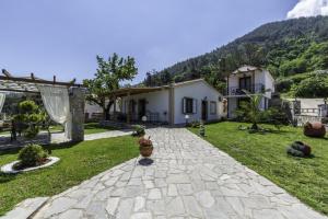 a backyard of a house with a stone pathway at Annas Villa in Skala Potamias