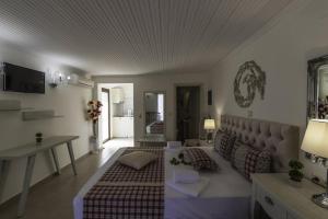 a living room with a bed and a couch at Annas Villa in Skala Potamias