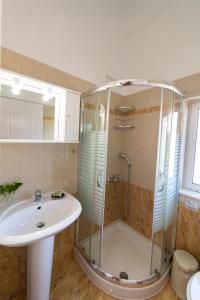 a bathroom with a sink and a shower at Villa Nektaria in Nikiana