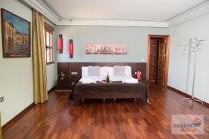 a bedroom with a bed and a wooden floor at HOLIDAYS MIRANA in Yecla +72 photos