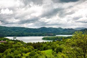 a view of a lake in the hills at Apartament Panorama 2 18 in Polańczyk