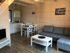 a living room with a couch and a table at White Houses Rewal in Rewal