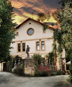 a building with a statue in front of it at U Zlate Brany Cesky raj in Libuň