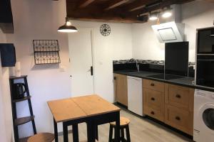 a kitchen with a table and a counter top at Studio de la Tour des rondes - tout confort plein-centre in Lavaur