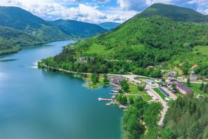 an aerial view of a river with mountains in the background at Hotel Plivsko jezero in Jajce