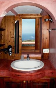 a bathroom with a sink and a window at Dammusi di Sofia in Pantelleria