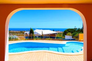 a swimming pool with a view of the ocean at Villa Esmeralda in Albufeira