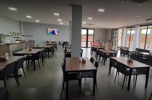 a dining room with tables and chairs in a restaurant at Hotel Alvorada - Trindade do Sul in Trindade