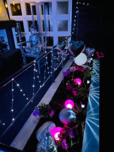 a balcony with lights and flowers and a statue at Ferienhaus Mone in Mayen