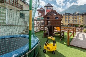 a small yellow toy car parked in a batting cage at Hotel Ghezzi in Andalo