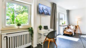 TV a/nebo společenská místnost v ubytování Studio HIRSCH56 - Zentral-Ruhig-Terrasse-Netflix