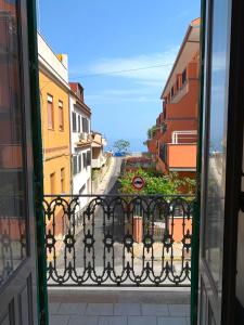 a view of a street from an open window at Casa Cristina in Alì Terme