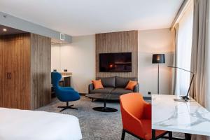 a hotel room with a bed and a couch at Radisson Blu Daugava Hotel, Riga in Riga