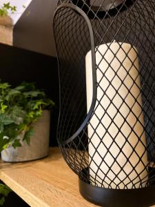 a black and white vase on a shelf with a plant at Hostel 19 Sopot in Sopot
