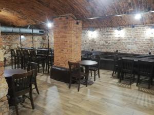 a restaurant with tables and chairs and a brick wall at Lorf Hostel&Coffee in Krakow