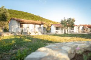 a house with a hill in the background at Janakis Garden Livadi Beach in (( Spile )) +22 photos