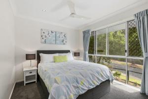 a bedroom with a bed and a large window at Amalfi in Point Lookout
