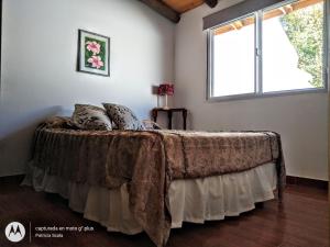 a bed in a room with a window at View Point Apart Pino in Villa Giardino