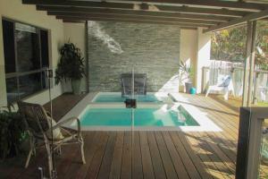 a swimming pool in a patio with a chair at Arthouse Six in Margaret River Town