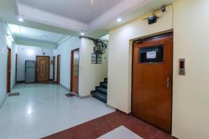 a hallway with a door and stairs in a building at Hotel Sai Vatika Guest House in Lucknow