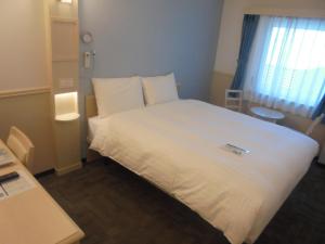 Кровать или кровати в номере Toyoko Inn Seoul Yeongdeungpo