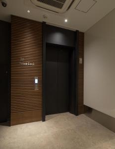 a large room with a large mirror and a large door at First Cabin Akasaka in Tokyo