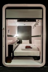 Posteľ alebo postele v izbe v ubytovaní First Cabin Akasaka