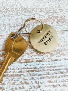 a key chain with the words unhappy survey on it at Pineapple Studio Byron Bay in Byron Bay