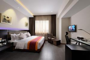 a hotel room with a bed and a desk at E-RED HOTEL KUANTAN in Kuantan