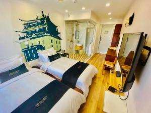 a hotel room with two beds and a television at Nomado Boutique Hotel in Ulaanbaatar