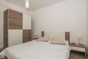 Posteľ alebo postele v izbe v ubytovaní Apartments Villa Hadria