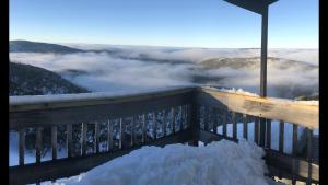 a pile of snow on a balcony with a view at Shamrock Apartment 4 in Mount Hotham