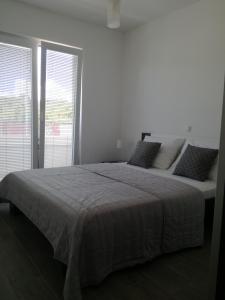 Posteľ alebo postele v izbe v ubytovaní Apartments Villa Hadria