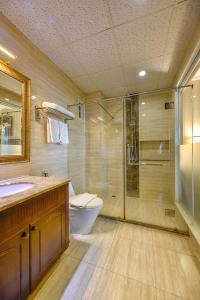 a bathroom with a shower and a toilet and a sink at Boutique Garden Hotel in Ho Chi Minh City