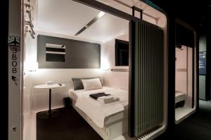 Postel nebo postele na pokoji v ubytování First Cabin Akasaka