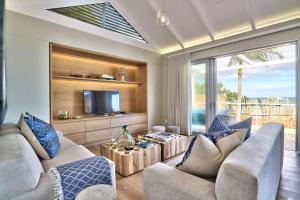 a living room with two couches and a tv at Rock Villa in Cape Town
