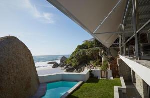 a view of the ocean from the side of a building at Rock Villa in Cape Town